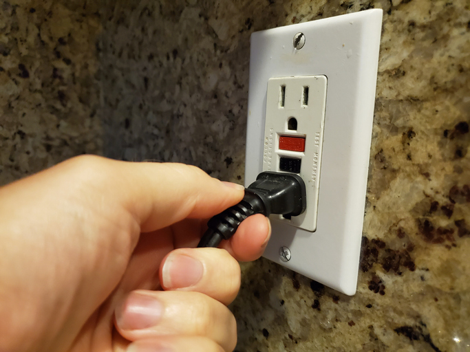 Tampa electrician testing kitchen outlets